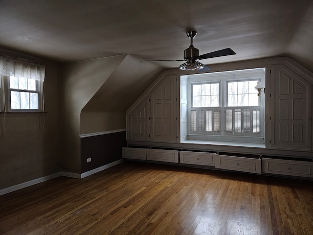 additional living space with ceiling fan, lofted ceiling, plenty of natural light, and hardwood / wood-style floors