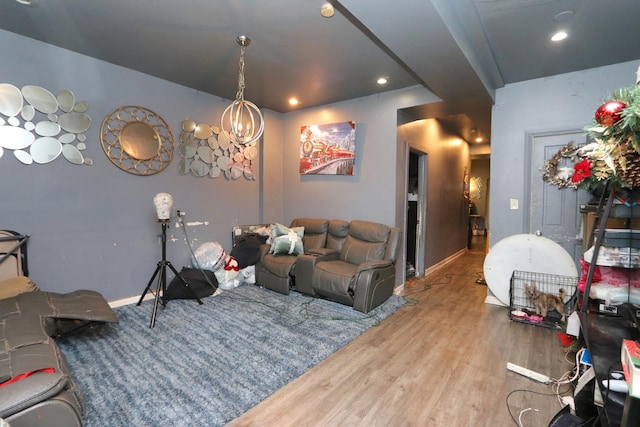 living room with hardwood / wood-style floors and an inviting chandelier