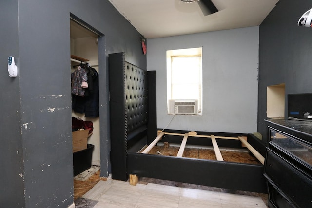 bedroom with cooling unit and ceiling fan