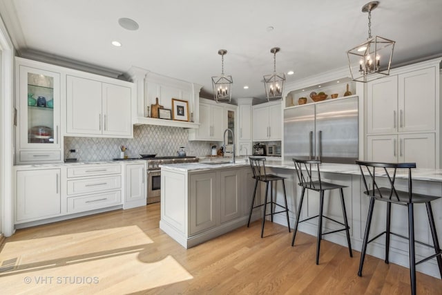 kitchen featuring white cabinetry, pendant lighting, and high quality appliances