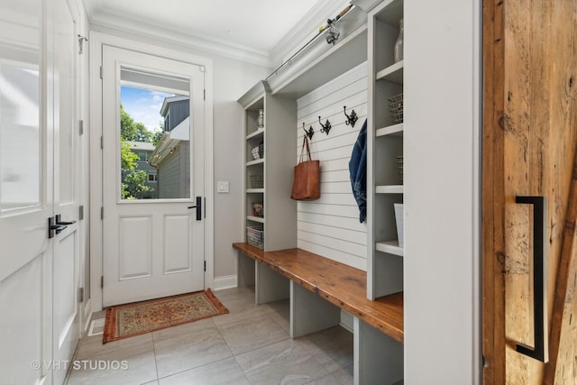 mudroom featuring crown molding and light tile patterned floors