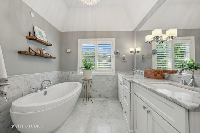 bathroom featuring vanity, plenty of natural light, tile walls, and an inviting chandelier