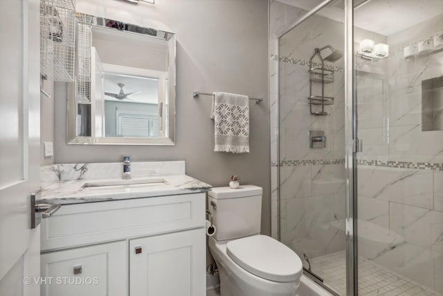 bathroom with vanity, toilet, and a shower with shower door