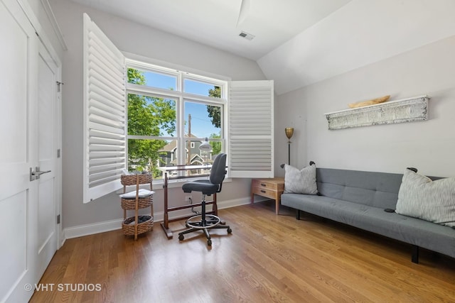 office area featuring lofted ceiling, hardwood / wood-style flooring, and a wealth of natural light