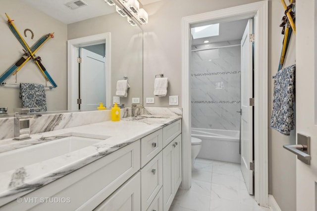 full bathroom with tiled shower / bath combo, vanity, and toilet