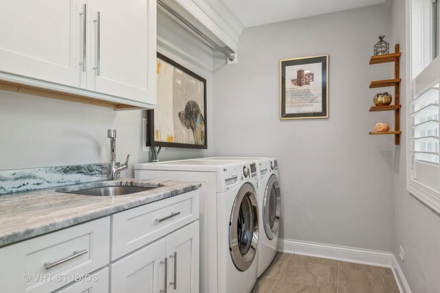 laundry area with sink, washer and clothes dryer, and cabinets