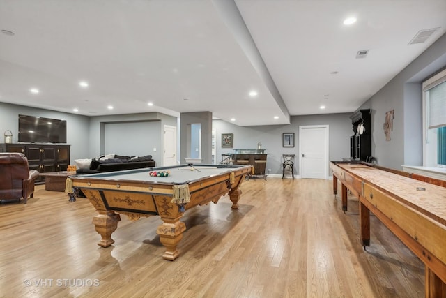 playroom with pool table, bar, and light hardwood / wood-style floors