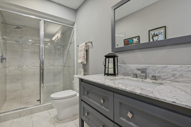 bathroom with vanity, toilet, and walk in shower