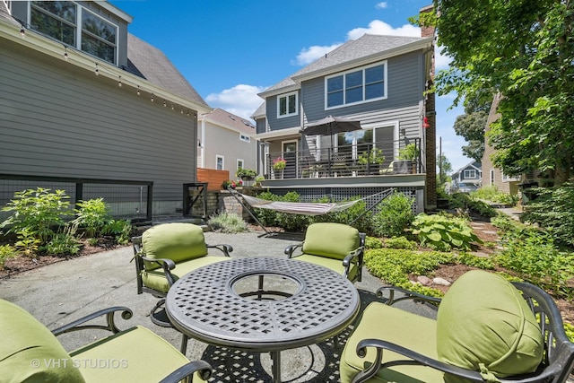 back of property with an outdoor fire pit and a patio area