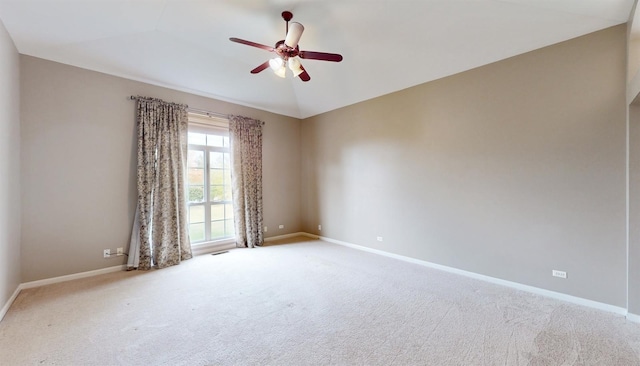 carpeted empty room with ceiling fan and lofted ceiling