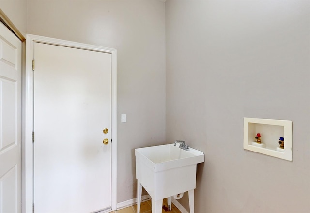 laundry area with hookup for a washing machine and sink