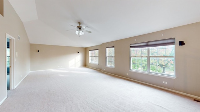 carpeted empty room with lofted ceiling and ceiling fan