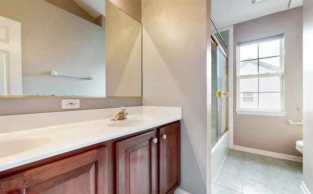 full bathroom featuring vanity, toilet, shower / bath combination with glass door, and a healthy amount of sunlight