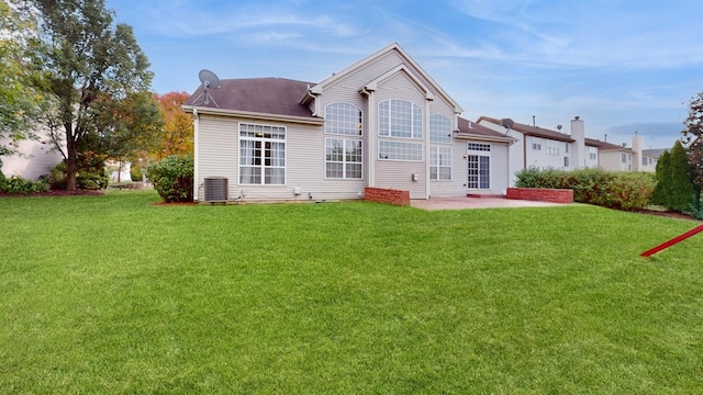 back of property featuring a yard, a patio area, and central air condition unit