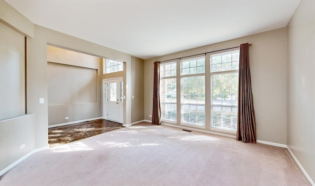 doorway to outside featuring carpet flooring