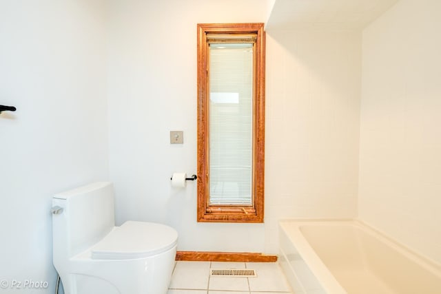 bathroom with tile patterned flooring, baseboards, visible vents, and toilet