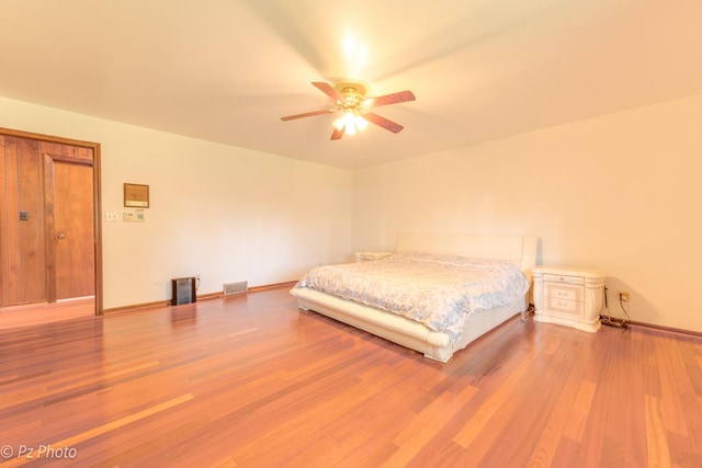 bedroom with visible vents, ceiling fan, baseboards, and wood finished floors