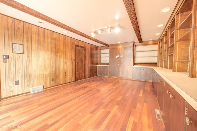 interior space featuring recessed lighting, wooden walls, wood finished floors, visible vents, and beamed ceiling