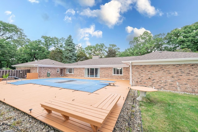 view of pool featuring fence and a wooden deck