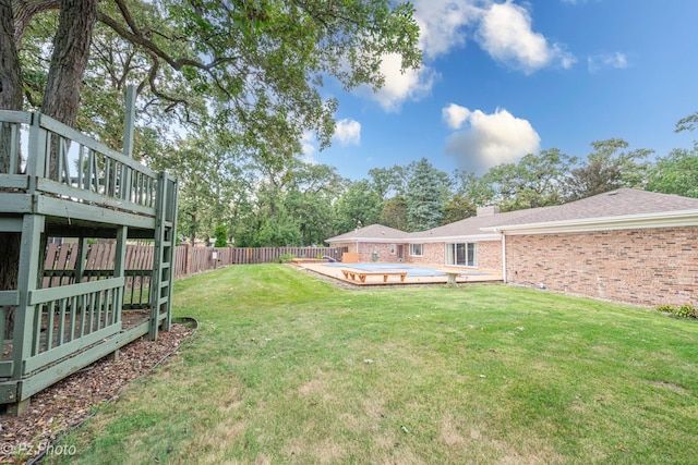 view of yard featuring a fenced backyard and a deck