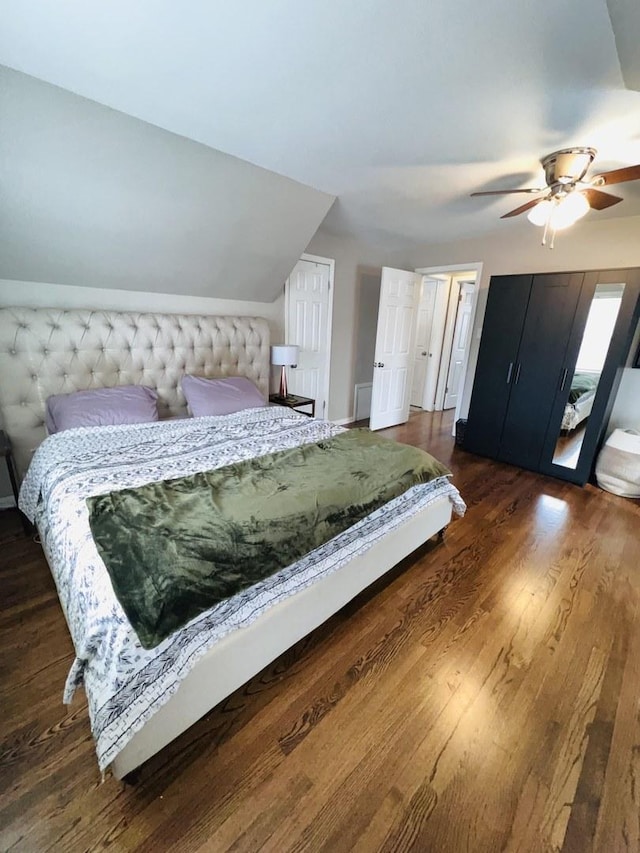 bedroom with dark wood-type flooring, ceiling fan, and lofted ceiling