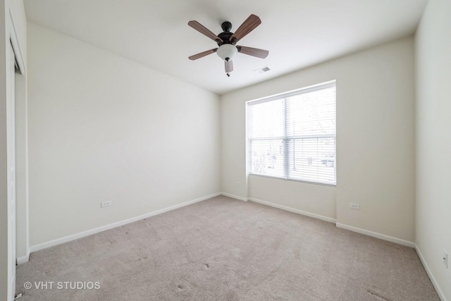 carpeted empty room with ceiling fan