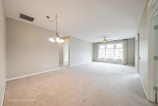 empty room with light carpet and ceiling fan with notable chandelier