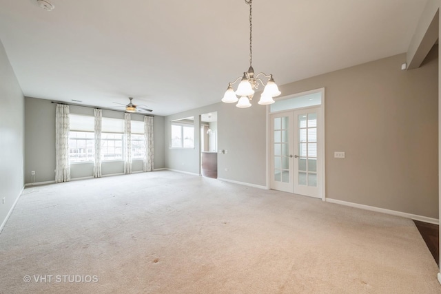 carpeted spare room featuring ceiling fan and french doors