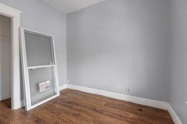 empty room featuring dark hardwood / wood-style flooring