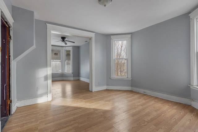 spare room featuring light hardwood / wood-style floors and ceiling fan