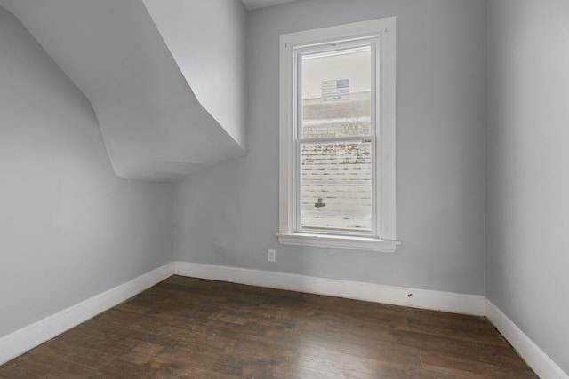 bonus room with dark hardwood / wood-style floors