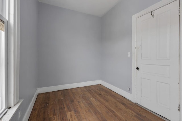 unfurnished room with dark hardwood / wood-style flooring