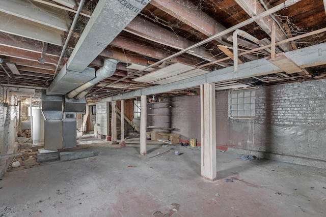 basement featuring heating unit and gas water heater