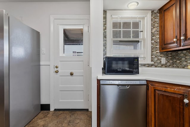 kitchen featuring stainless steel appliances and decorative backsplash