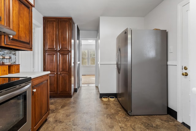 kitchen featuring stainless steel appliances and backsplash