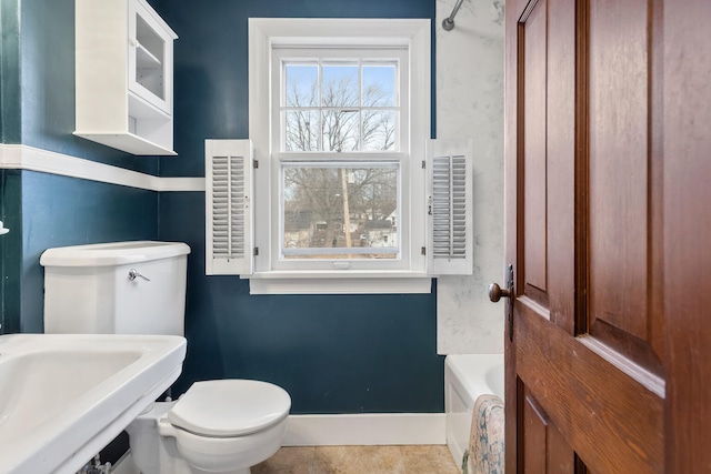 bathroom with toilet, tile patterned flooring, sink, and a bathtub