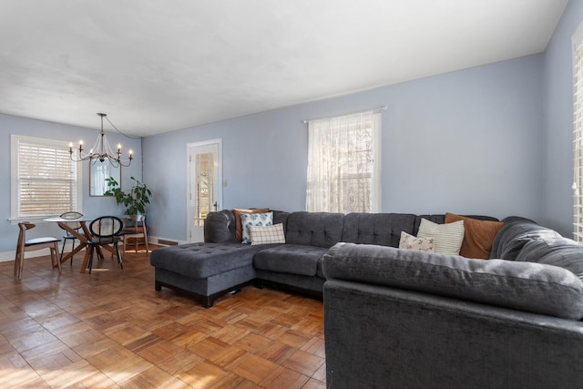 living room featuring parquet floors and an inviting chandelier