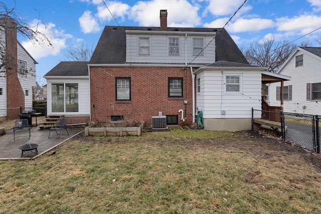 rear view of property with central AC unit, a lawn, and a patio area