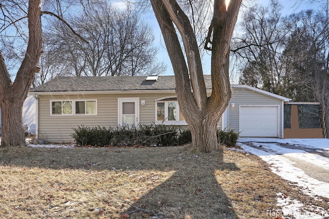 single story home featuring a garage and a front lawn