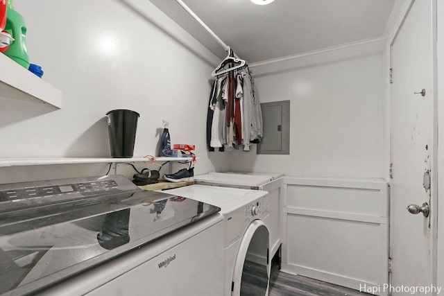 laundry area featuring dark hardwood / wood-style flooring, crown molding, electric panel, and washing machine and clothes dryer