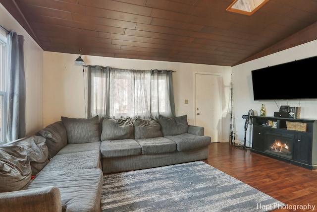 living room featuring dark hardwood / wood-style flooring, vaulted ceiling, and wooden ceiling