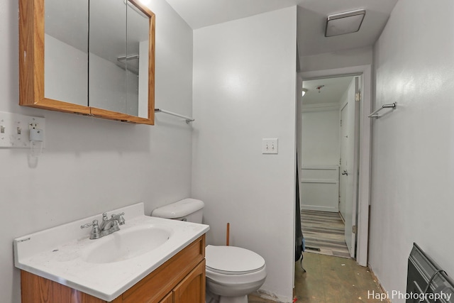 bathroom with vanity, concrete floors, and toilet