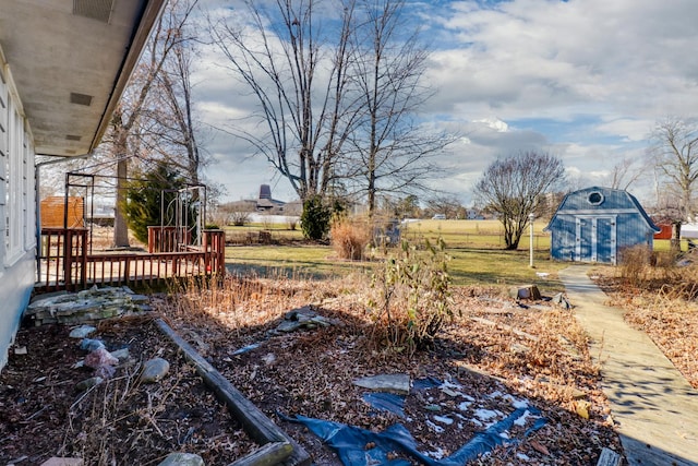 view of yard featuring a storage shed and a wooden deck