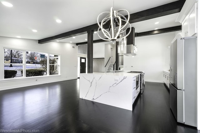 kitchen with appliances with stainless steel finishes, beamed ceiling, white cabinets, hanging light fixtures, and light stone counters