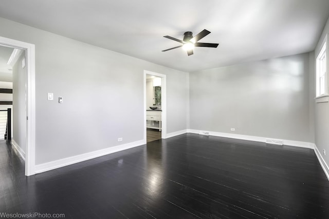 empty room with dark hardwood / wood-style flooring and ceiling fan