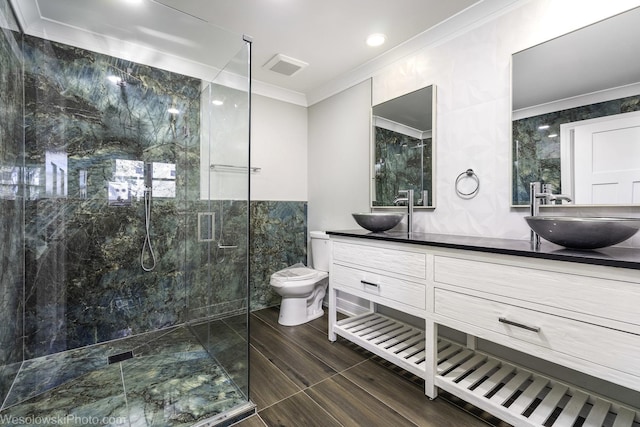 bathroom with tile walls, toilet, vanity, walk in shower, and crown molding