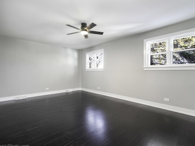 unfurnished room with ceiling fan, plenty of natural light, and dark hardwood / wood-style floors