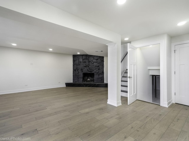 unfurnished living room featuring light wood-type flooring and a fireplace