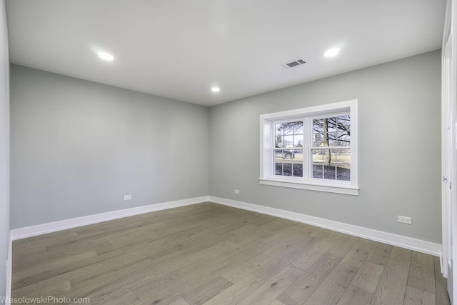 empty room with light hardwood / wood-style flooring