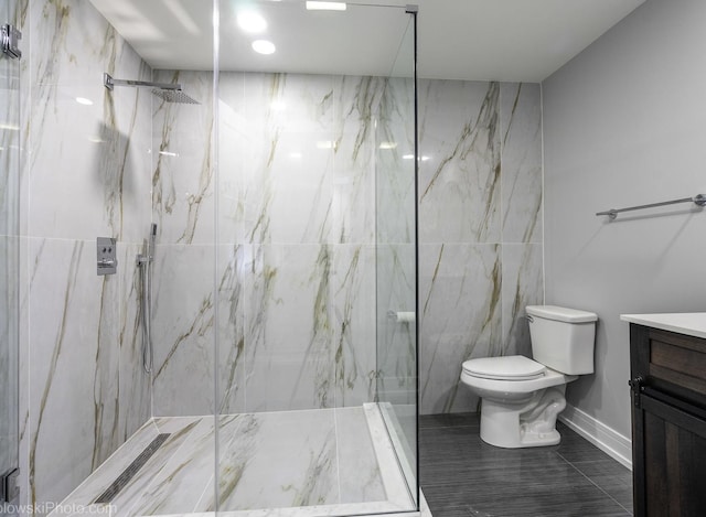 bathroom featuring vanity, toilet, and tiled shower